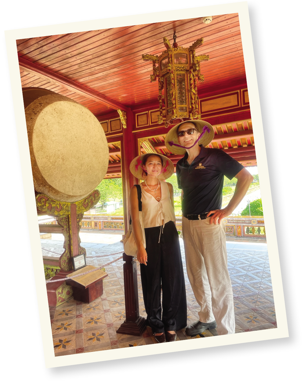 A travel photo of two people wearing hats in Vietnam.