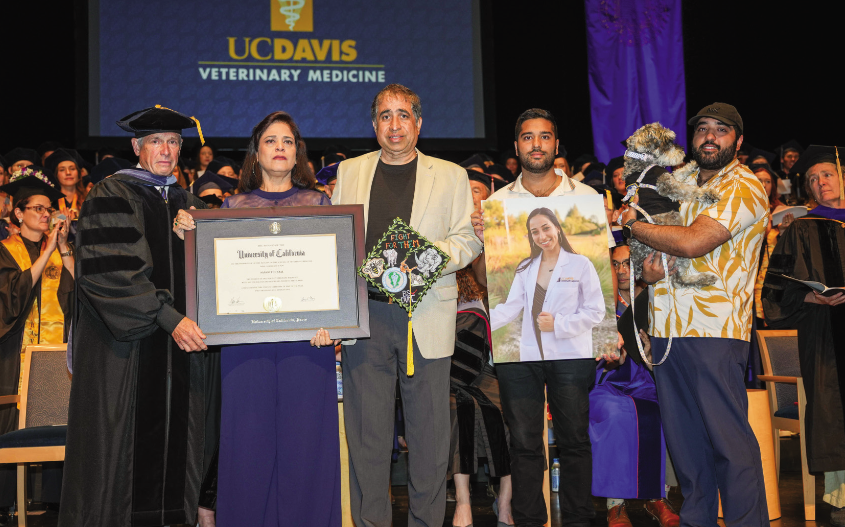 Sunny Thrukal's family on stage accepting her degree.