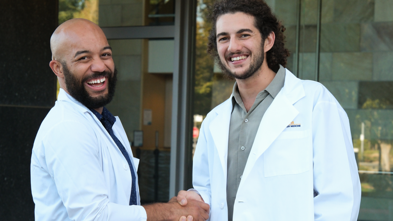 Dr. Sean Gadson and Leonardo Lahijani shake hands.