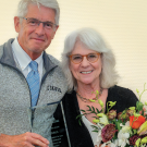 Nancy Ehrlich holding flowers with Dean Mark Stetter.