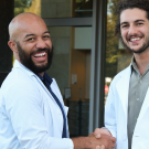 Dr. Sean Gadson and Leonardo Lahijani shake hands.